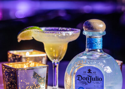 close up shot of a margarita with a bottle of Don Julio